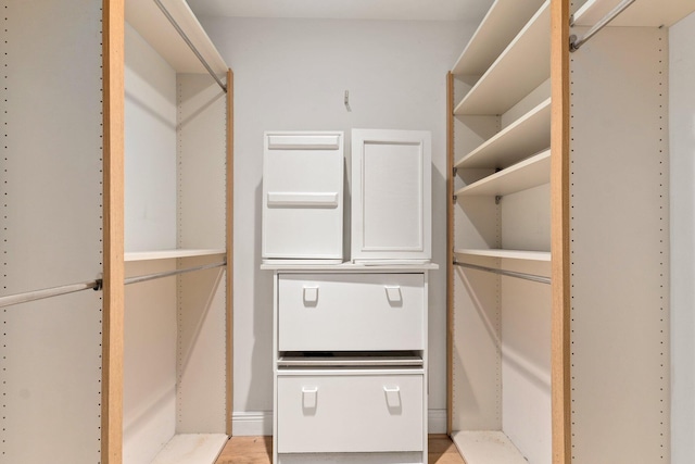 walk in closet featuring light hardwood / wood-style flooring