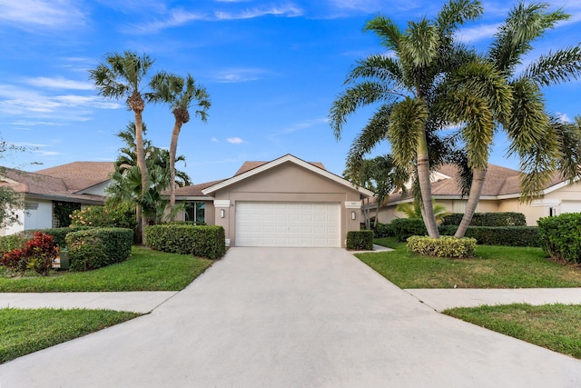 single story home with a garage and a front lawn