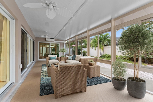 sunroom with vaulted ceiling, a wall unit AC, ceiling fan, and a healthy amount of sunlight