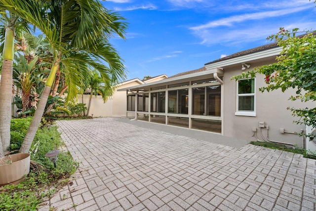 view of patio / terrace with a sunroom