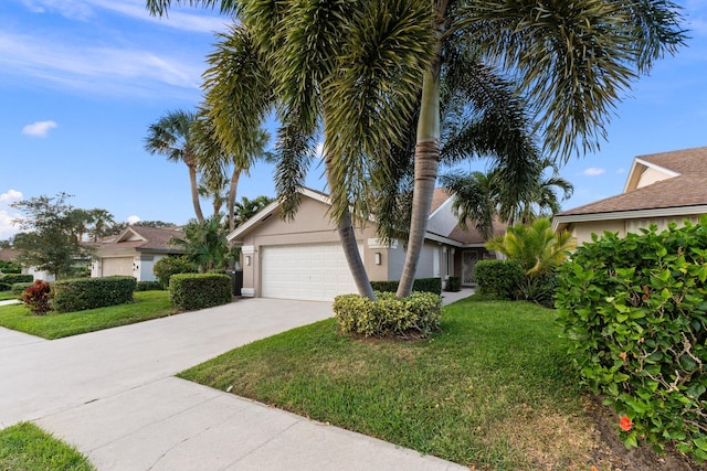 view of front of property with a front yard and a garage