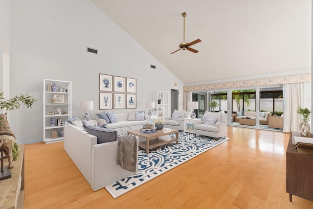 living room featuring ceiling fan, light hardwood / wood-style flooring, and high vaulted ceiling