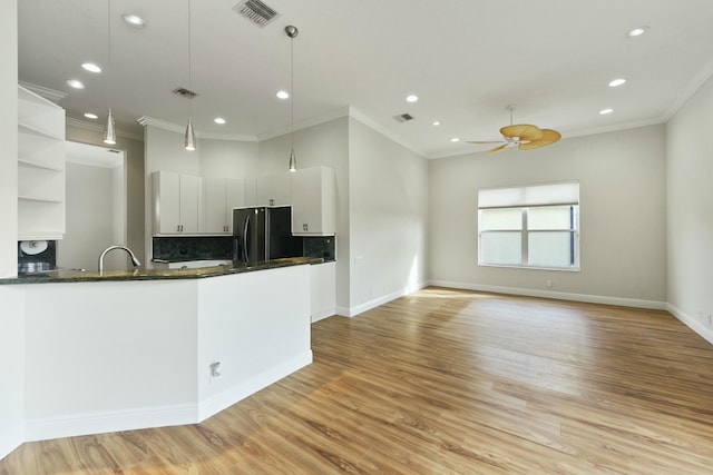 kitchen with visible vents, white cabinets, freestanding refrigerator, open shelves, and light wood finished floors