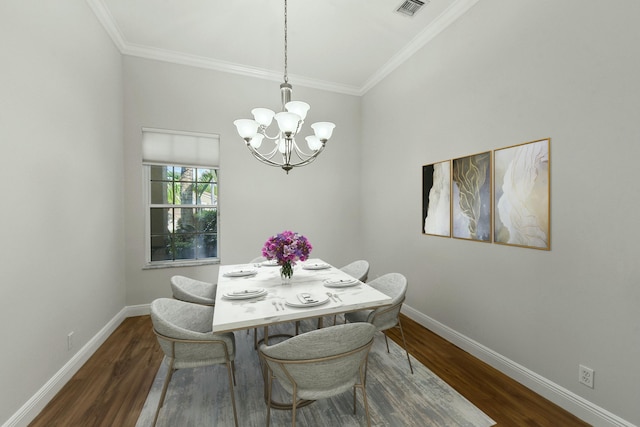 dining space featuring a chandelier, dark wood-type flooring, visible vents, and baseboards