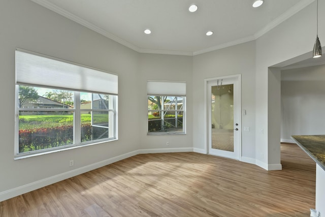 unfurnished room with light wood finished floors, baseboards, ornamental molding, and recessed lighting