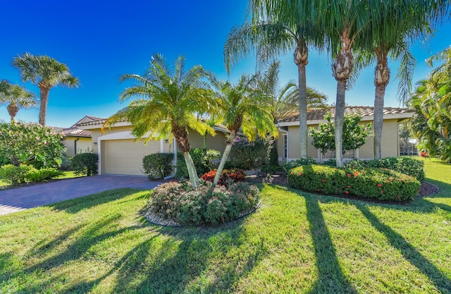 view of front of home with a front yard and a garage