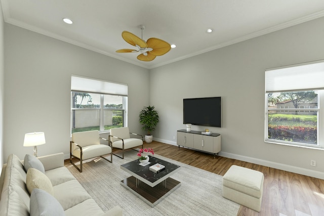 living room with recessed lighting, crown molding, baseboards, and wood finished floors