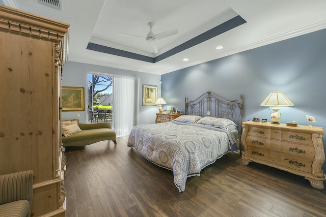 bedroom featuring access to exterior, a tray ceiling, crown molding, visible vents, and hardwood / wood-style floors