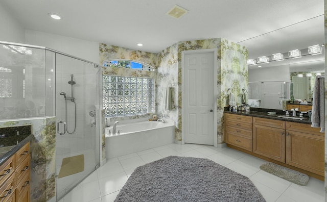 full bathroom with a stall shower, tile patterned flooring, a bath, and vanity