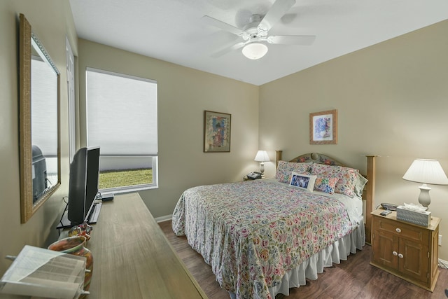 bedroom featuring ceiling fan, dark wood finished floors, and baseboards