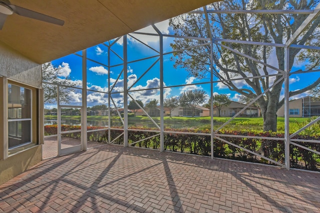 unfurnished sunroom with a ceiling fan