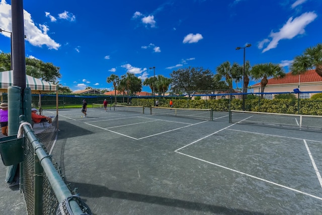 view of tennis court featuring fence