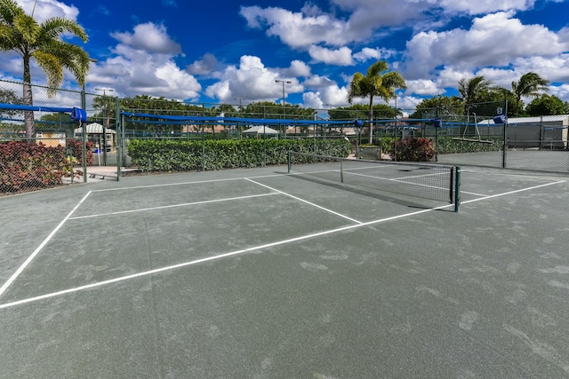 view of tennis court with fence