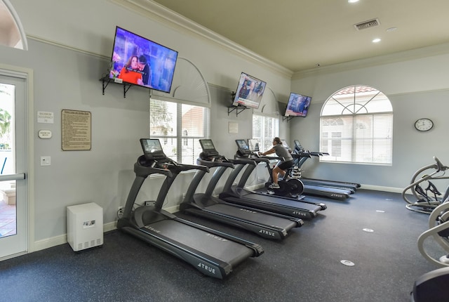 gym featuring ornamental molding, visible vents, and baseboards