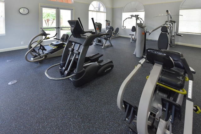 workout area featuring baseboards and french doors