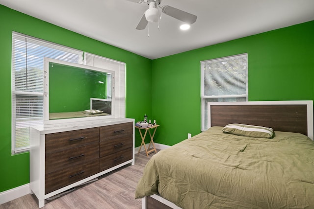 bedroom with ceiling fan and light wood-type flooring