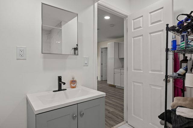 bathroom with hardwood / wood-style floors and vanity