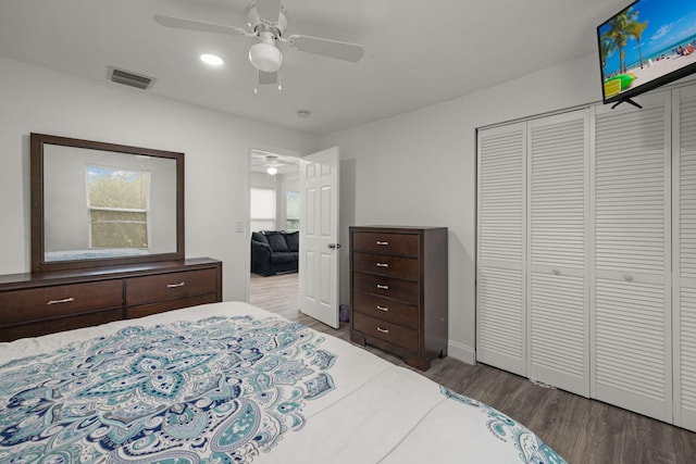 bedroom with a closet, ceiling fan, and dark hardwood / wood-style flooring