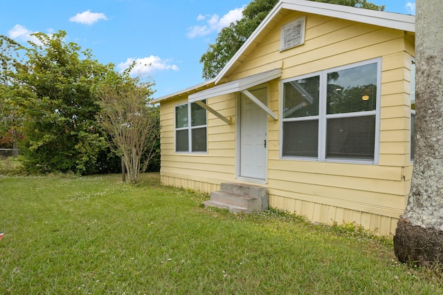 rear view of house with a yard