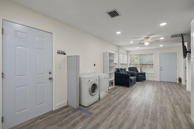 washroom featuring light hardwood / wood-style flooring, ceiling fan, and washing machine and clothes dryer