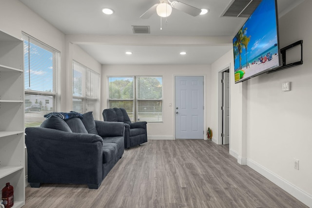 living room with ceiling fan and hardwood / wood-style floors