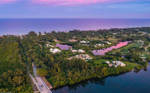 aerial view at dusk with a water view