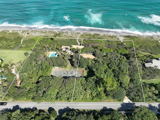 bird's eye view featuring a water view and a beach view