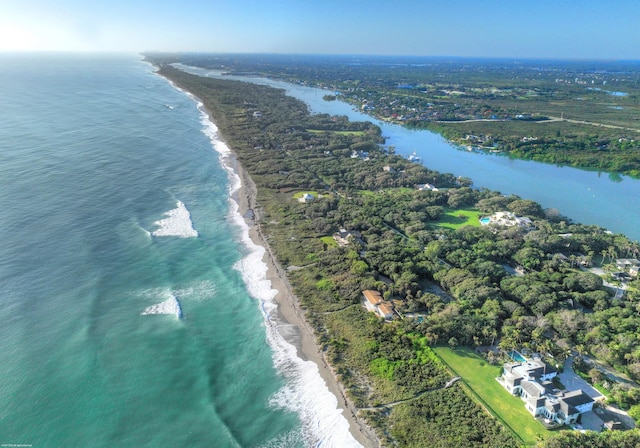 drone / aerial view featuring a beach view and a water view