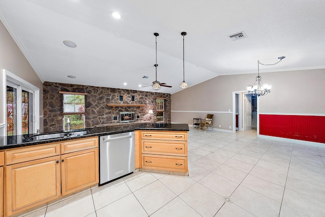 kitchen featuring lofted ceiling, dishwasher, hanging light fixtures, a fireplace, and dark stone counters