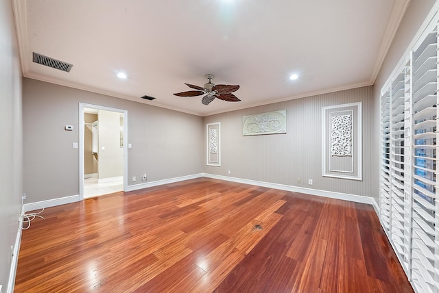 spare room with hardwood / wood-style flooring, crown molding, and ceiling fan