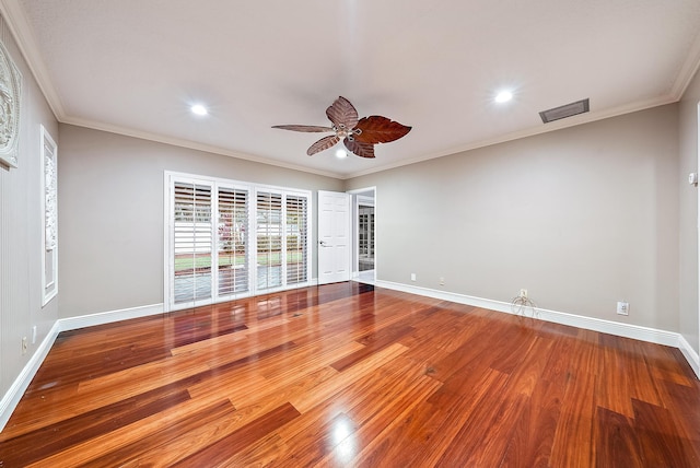 empty room featuring ceiling fan, wood-type flooring, and ornamental molding