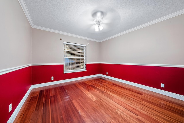 spare room with ceiling fan, ornamental molding, hardwood / wood-style floors, and a textured ceiling