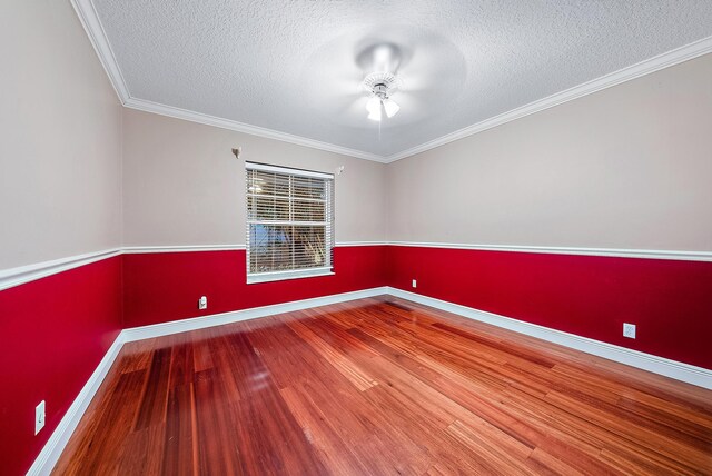 empty room with ornamental molding, a textured ceiling, and hardwood / wood-style flooring