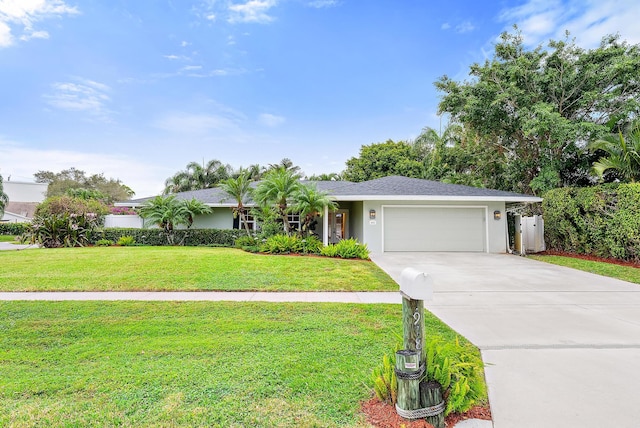 single story home featuring a garage and a front lawn