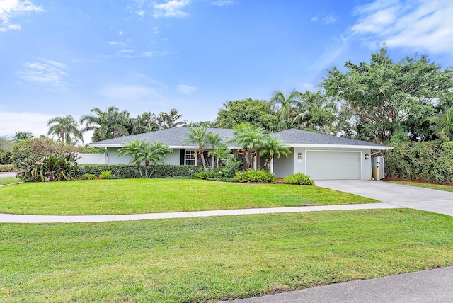 ranch-style house featuring a garage and a front lawn