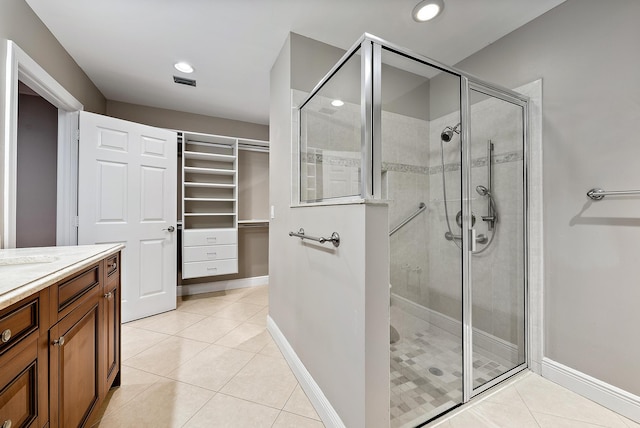 bathroom with tile patterned flooring, vanity, and an enclosed shower