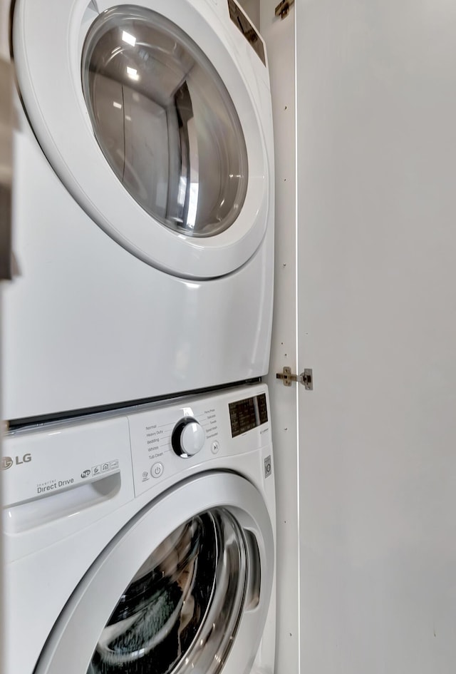 clothes washing area featuring stacked washer / drying machine