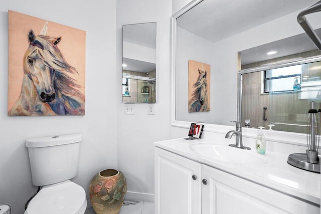 bathroom with vanity, toilet, and an enclosed shower