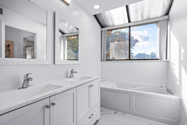 bathroom with vanity and a bath