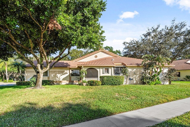 mediterranean / spanish-style house featuring a front yard