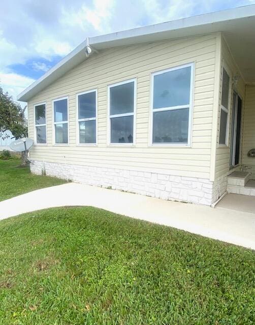 view of property exterior featuring a lawn