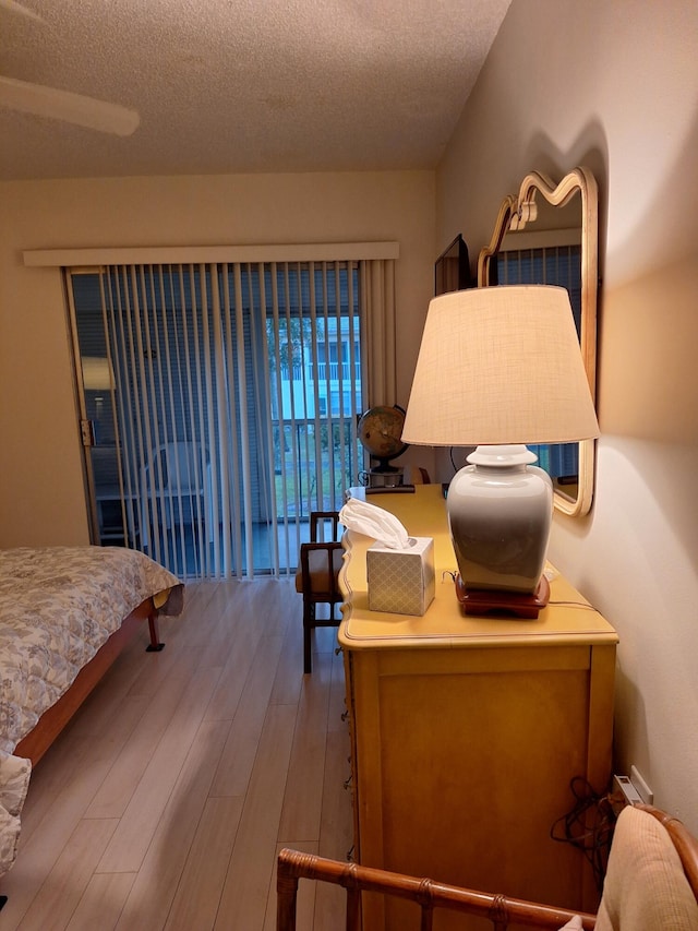 bedroom with hardwood / wood-style floors and a textured ceiling