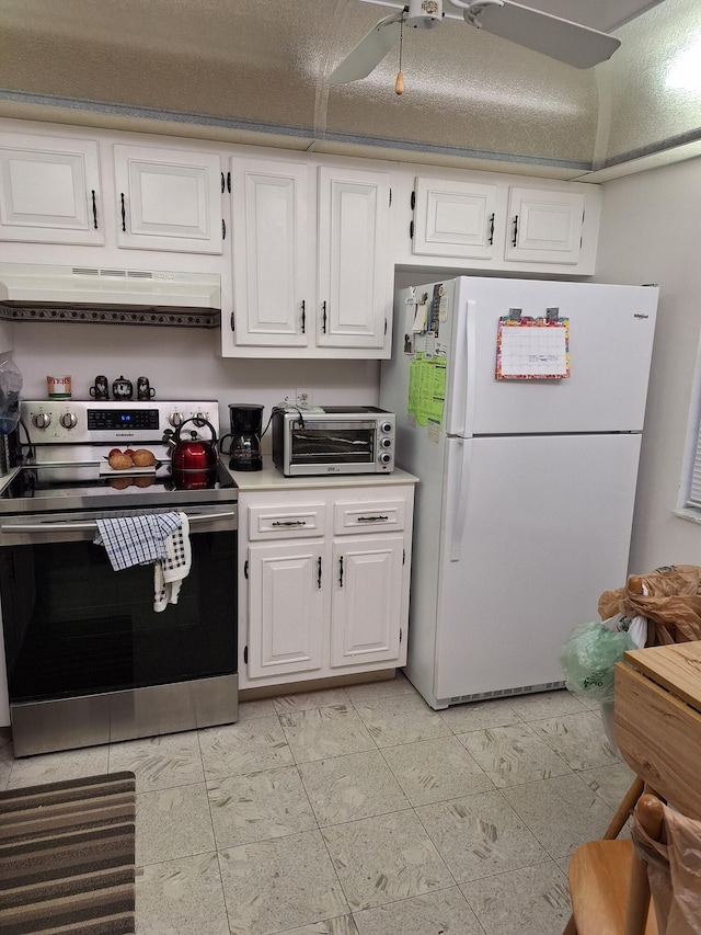 kitchen with ceiling fan, exhaust hood, white refrigerator, white cabinets, and stainless steel electric range oven