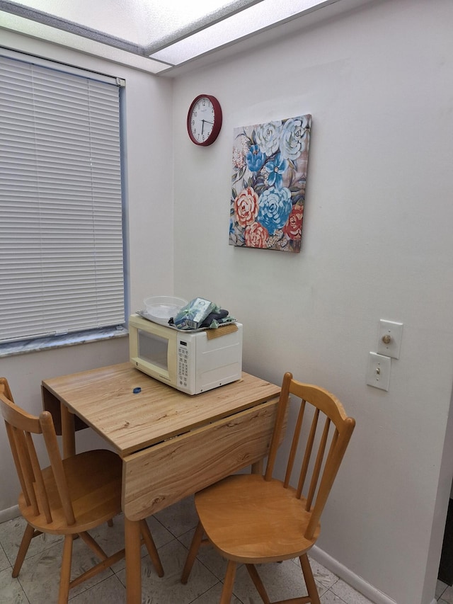 dining area featuring light tile patterned flooring