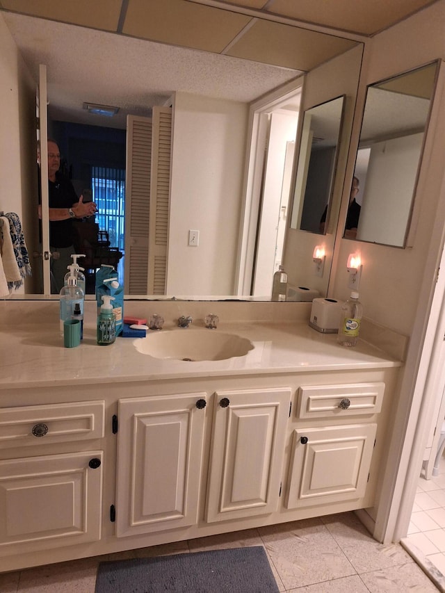 bathroom with tile patterned floors and vanity