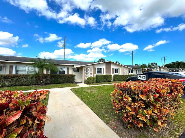 ranch-style house with a front lawn