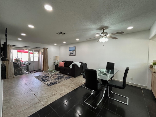 dining area with a textured ceiling and ceiling fan