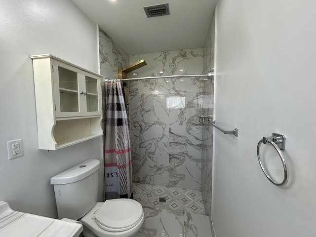 bathroom featuring toilet and a shower with shower curtain