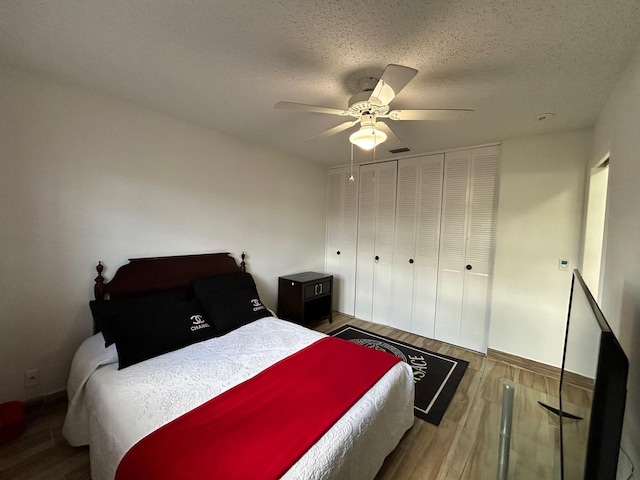 2522 Emory Dr E Unit I, West Palm Beach, FL 33415 - bedroom with wood finished floors, a textured ceiling, ceiling fan, baseboards, and a closet