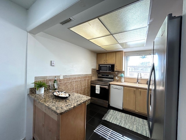 kitchen with stainless steel fridge, range with electric cooktop, sink, dark tile patterned flooring, and dishwasher